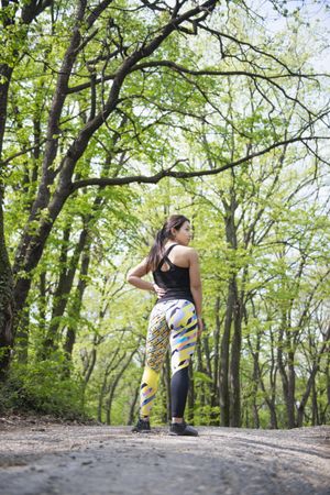 Rear view of woman in athletic gear in the forest