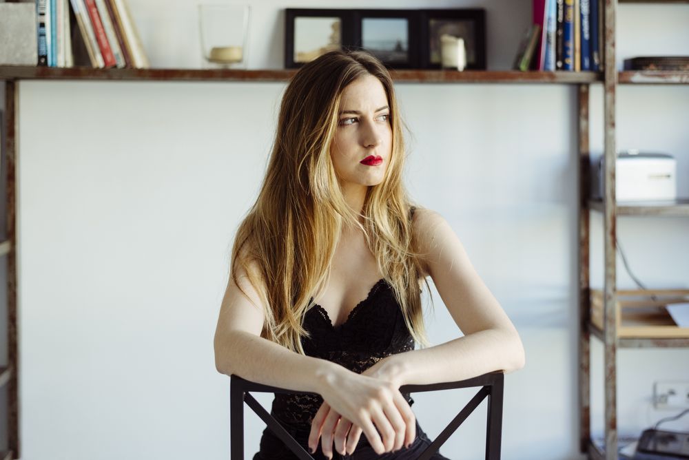 woman in bra sitting on chair