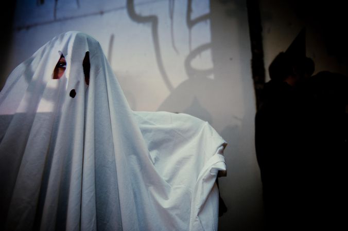 Close up of person in sheet ghost costume