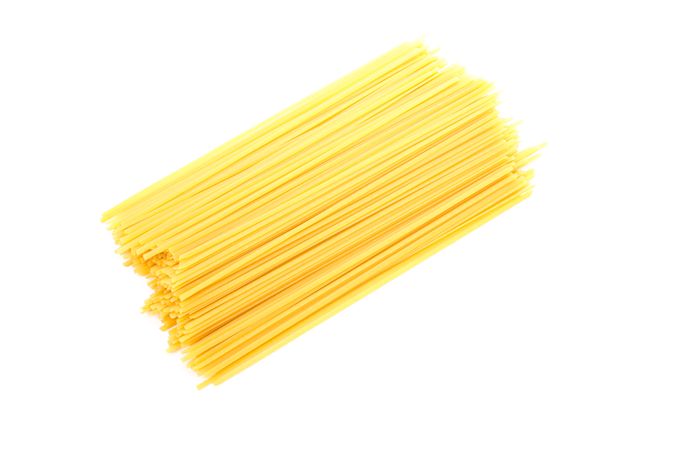 Pasta isolated on light background, top view. Uncooked whole wheat pasta