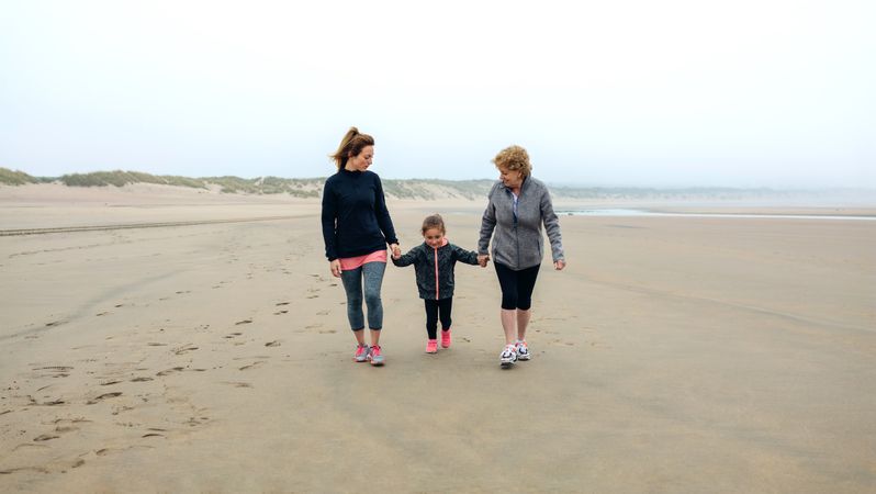 Three generations walking on the beach