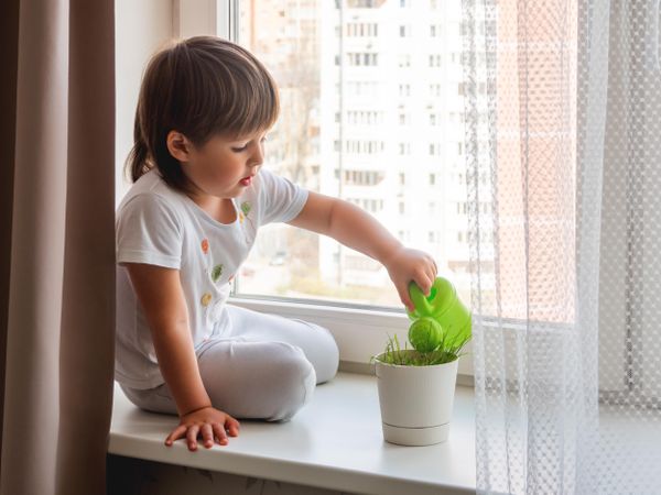 Child with green watering can