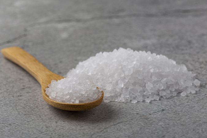 Handful of coarse salt on the table.