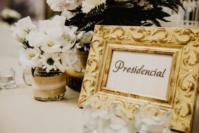 Photo frame near flowers on table
