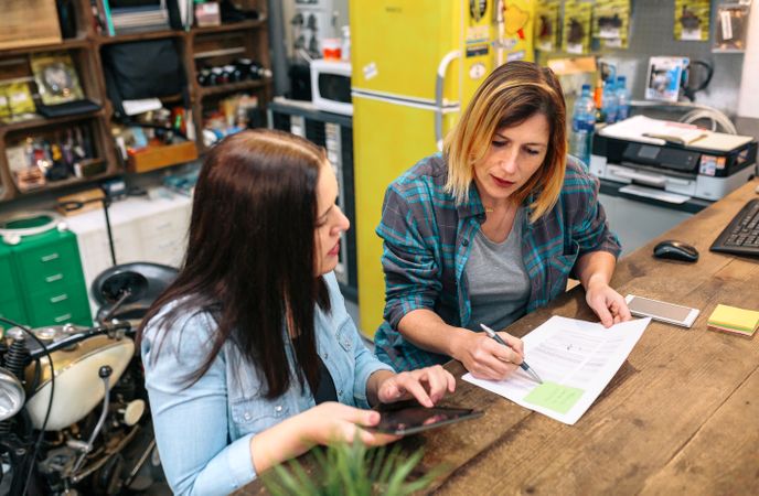 Women entrepreneur reviewing the balance with expense and cost of small business.