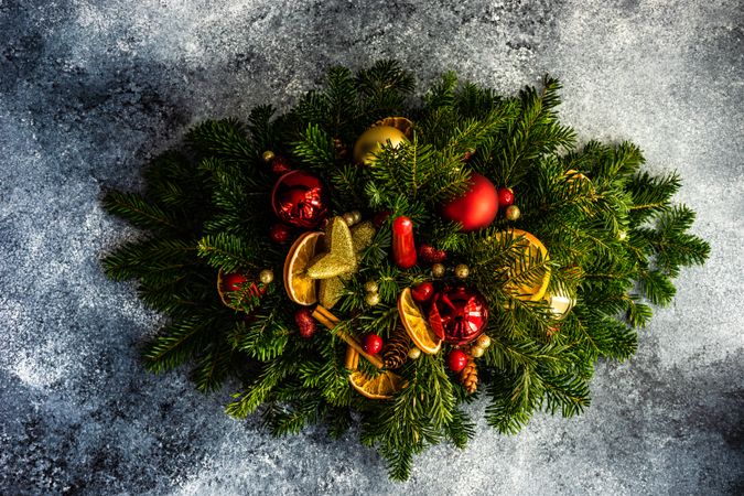 Top view of red and gold Christmas decorations in pine branch