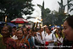 Group of women with torches marches during Nyepi day 0LkdXb