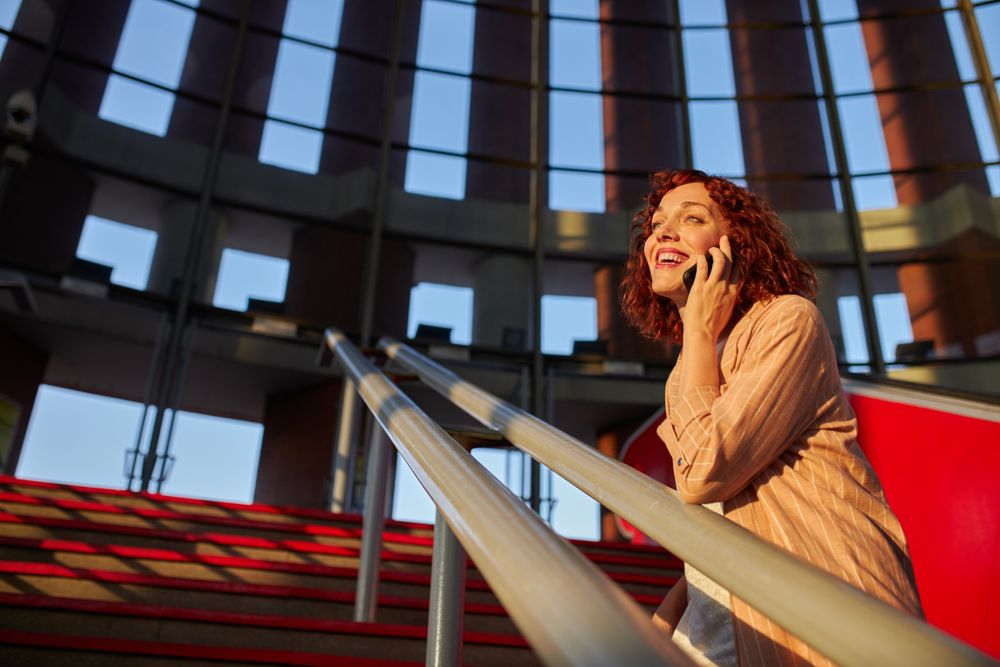 young female communicating via smartphone at station