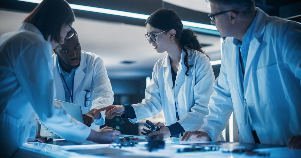 Portrait of a Group of Industrial Robotics Engineers Working on Humanoid Robot, Consulting with Specialists, Analyzing Electronic Components.