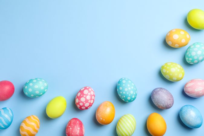Flat lay composition with Easter eggs on color background, space for text. Top view