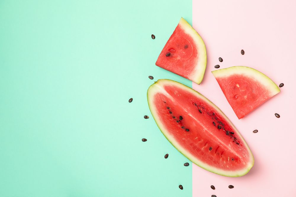Composition with watermelon slices on two tone background, top view