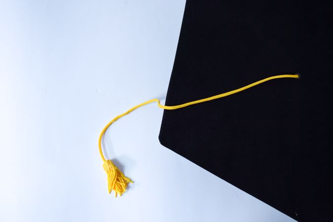 Top view of graduation cap with yellow tassel