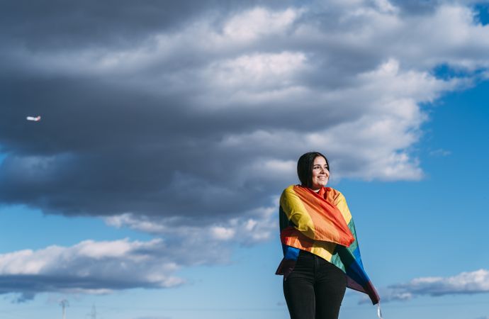 Young woman with rainbow flag