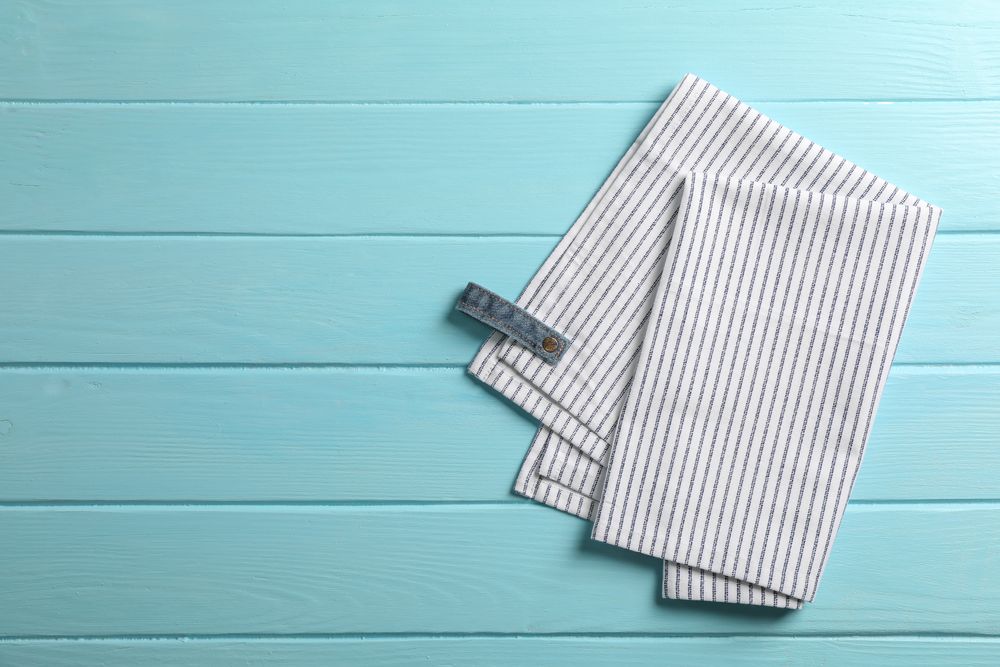 Fabric napkins on color background, space for text