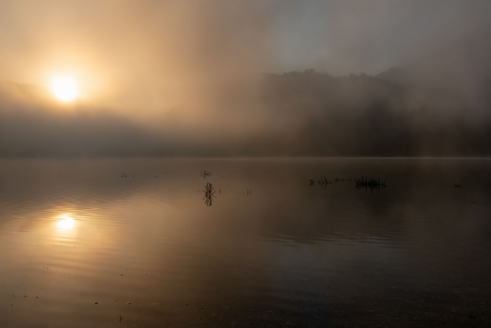 Sunrise on a foggy morning over Lake Sylvenstein in Bavaria, Germany