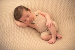 portrait of baby asleep in bed