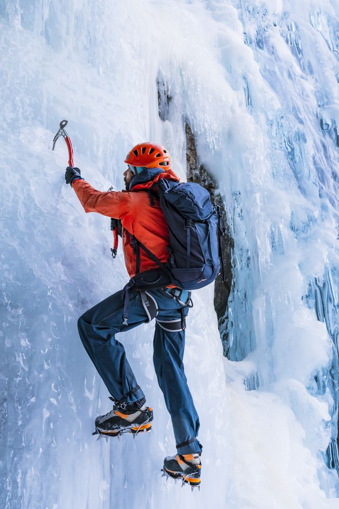 Confident climber using equipment for ice climbing