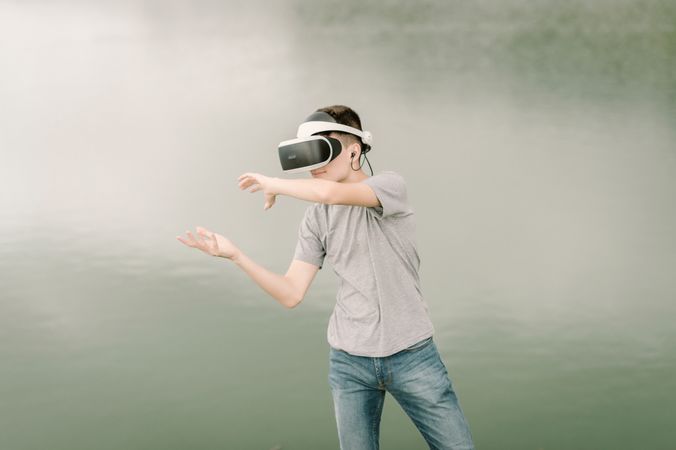 Young teenager with virtual reality glasses outdoors