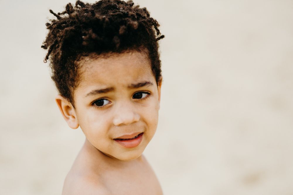 Funny Black boy on beach