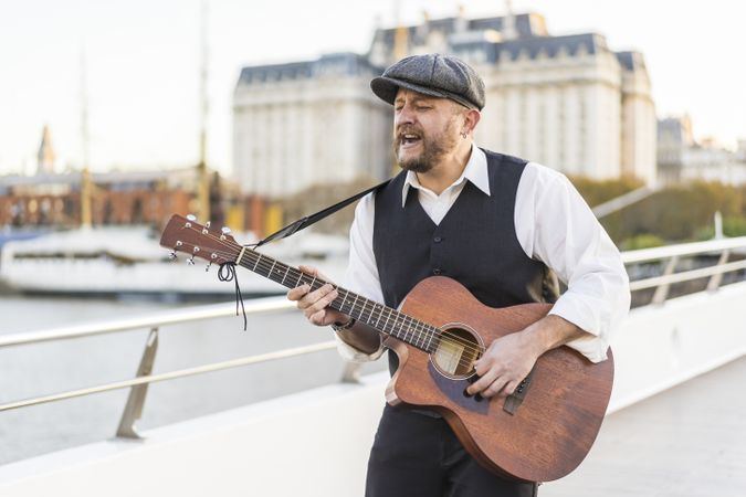 A street musician performing classic songs on guitar.