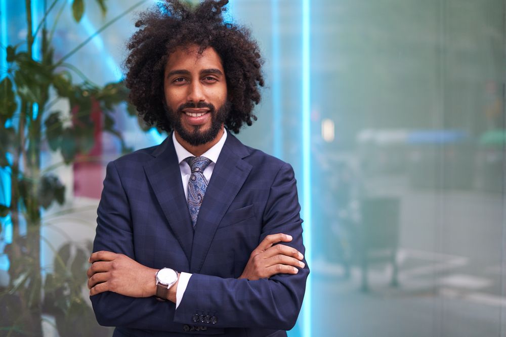 Successful Black businessman in suit smiling