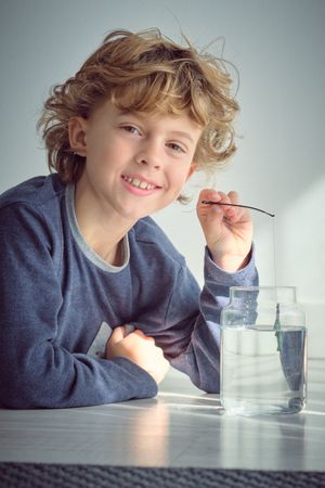 Smiling boy playing with toy fishing rod