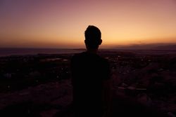 Silhouette of male enjoying picturesque sunset