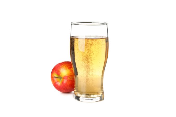 Glass of apple cider isolated on blank background
