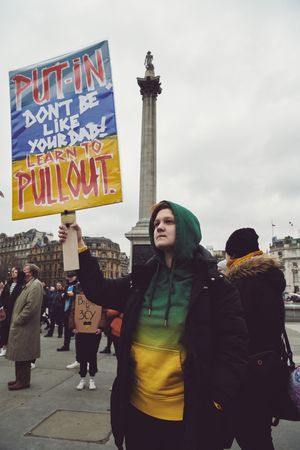 London, England, United Kingdom - March 5 2022: Woman in hoodie with anti-Putin sign