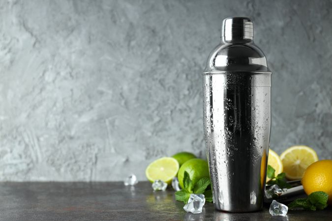 Concept of preparing cocktail, shaker, space for text