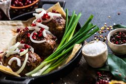 Georgian plate of abkhazura meat cutlets with pomegranate seeds and onions