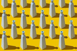 Painted glass bottles on yellow background