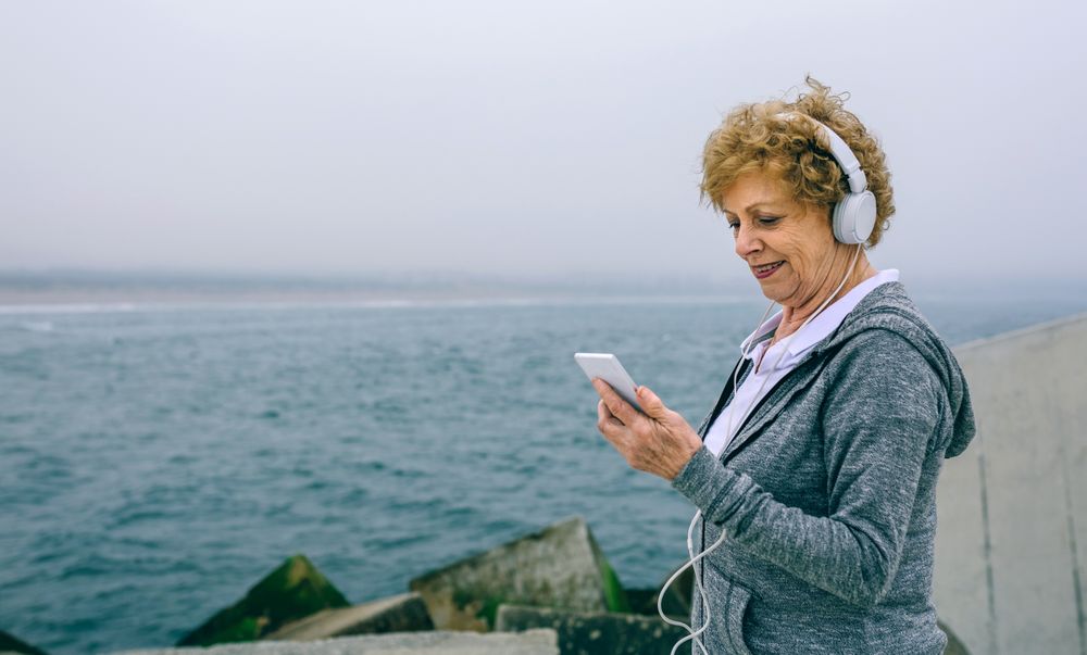 Older sportswoman looking at her smartphone