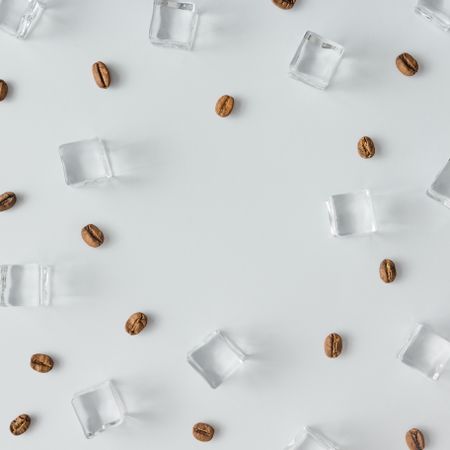Coffee beans and ice cubes pattern on bright background