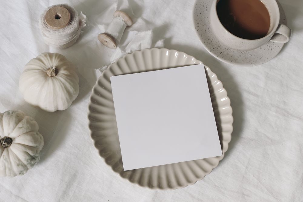 Winter, autumn stationery; fall mockup scene with square greeting card, invitation, silk ribbons on table and pumpkins