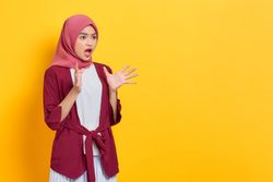 Incredulous woman in red headscarf looking to the side surprised
