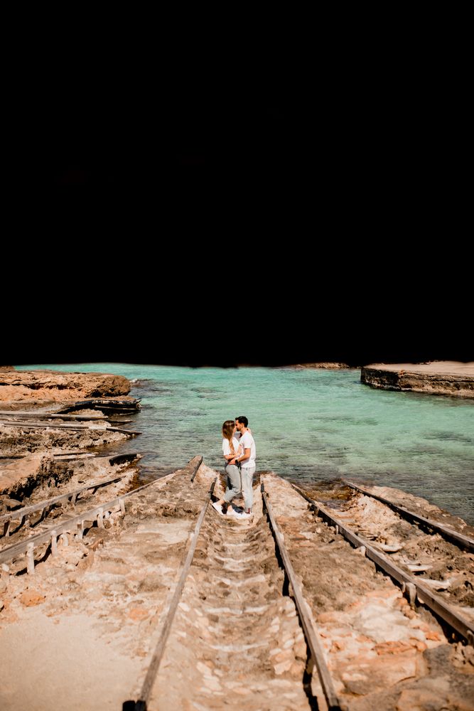 Amorous couple hugging on coastal pier