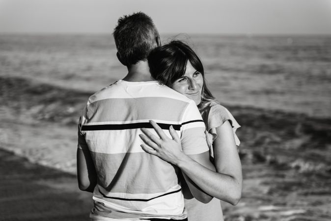 Adult couple embracing near sea