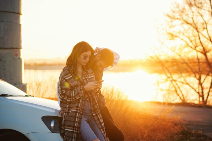 Couple near car use mobile app map