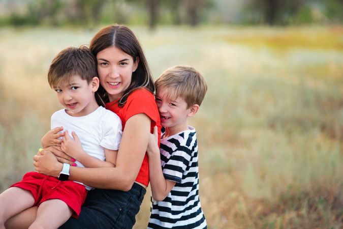 Loving mom with two sons outdoors