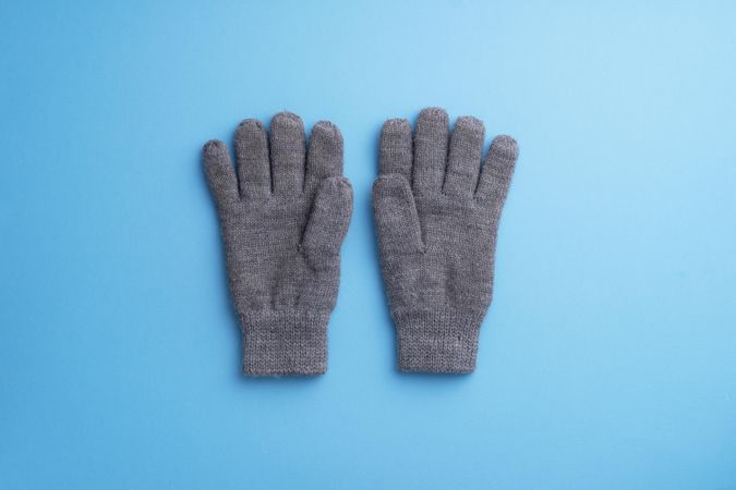 Gray gloves over blue background