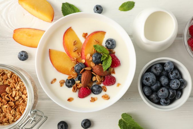 Flat lay composition with parfaits dessert and ingredients on wooden background