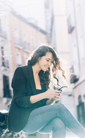 Young female walking with smartphone