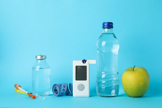 Diabetes accessories on blue background, space for text