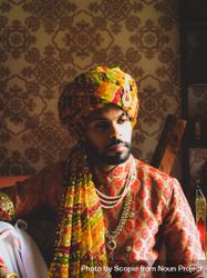 Portrait of Indian man wearing turban sitting indoor 5w8k94