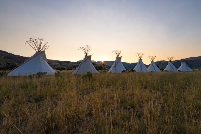 Montana, United States - August 17, 2022: Line of teepees in the Rocky mountains at dusk