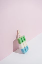 Colorful ice cream popsicle on pastel pink background