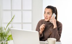 a thoughtful woman having a conversation on the phone