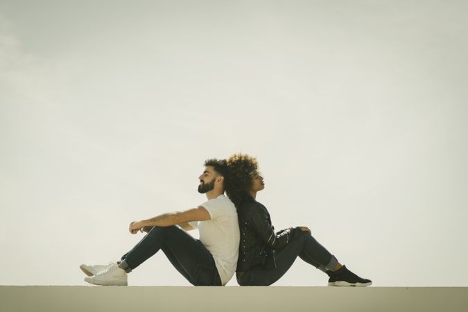 Couple sitting on wall