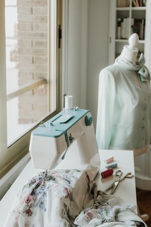 Dummy with blouse near sewing machine